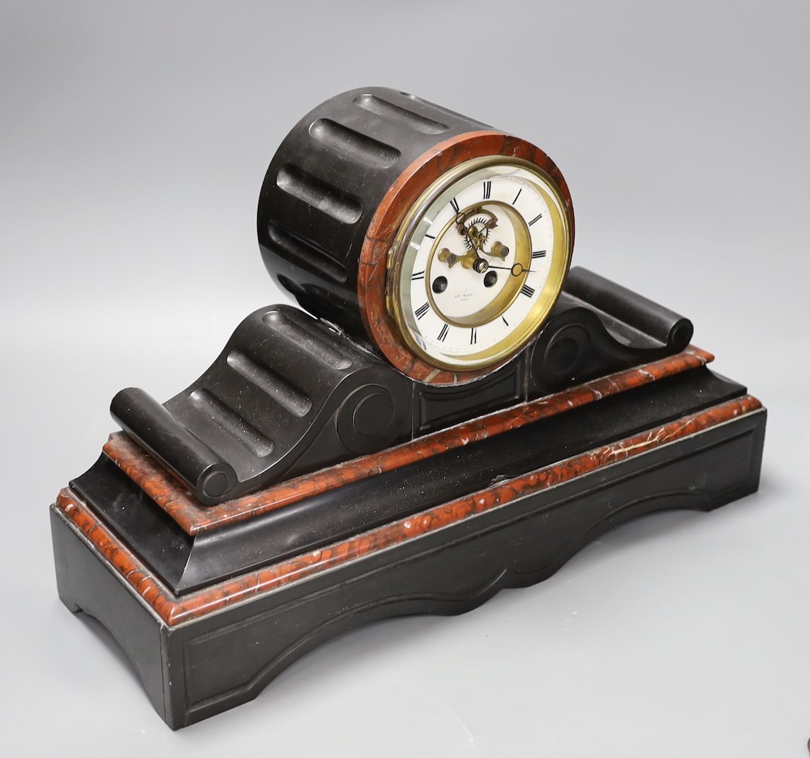 A French black slate and rouge marble mantel clock by Henry Marc, with key and pendulum, 28.5cm tall